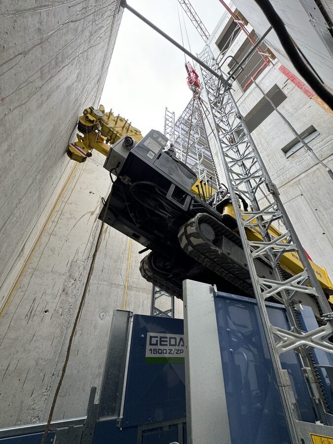 Blick von unten auf das Raupenfahrwerk des schräg hängenden Spinnenkrans