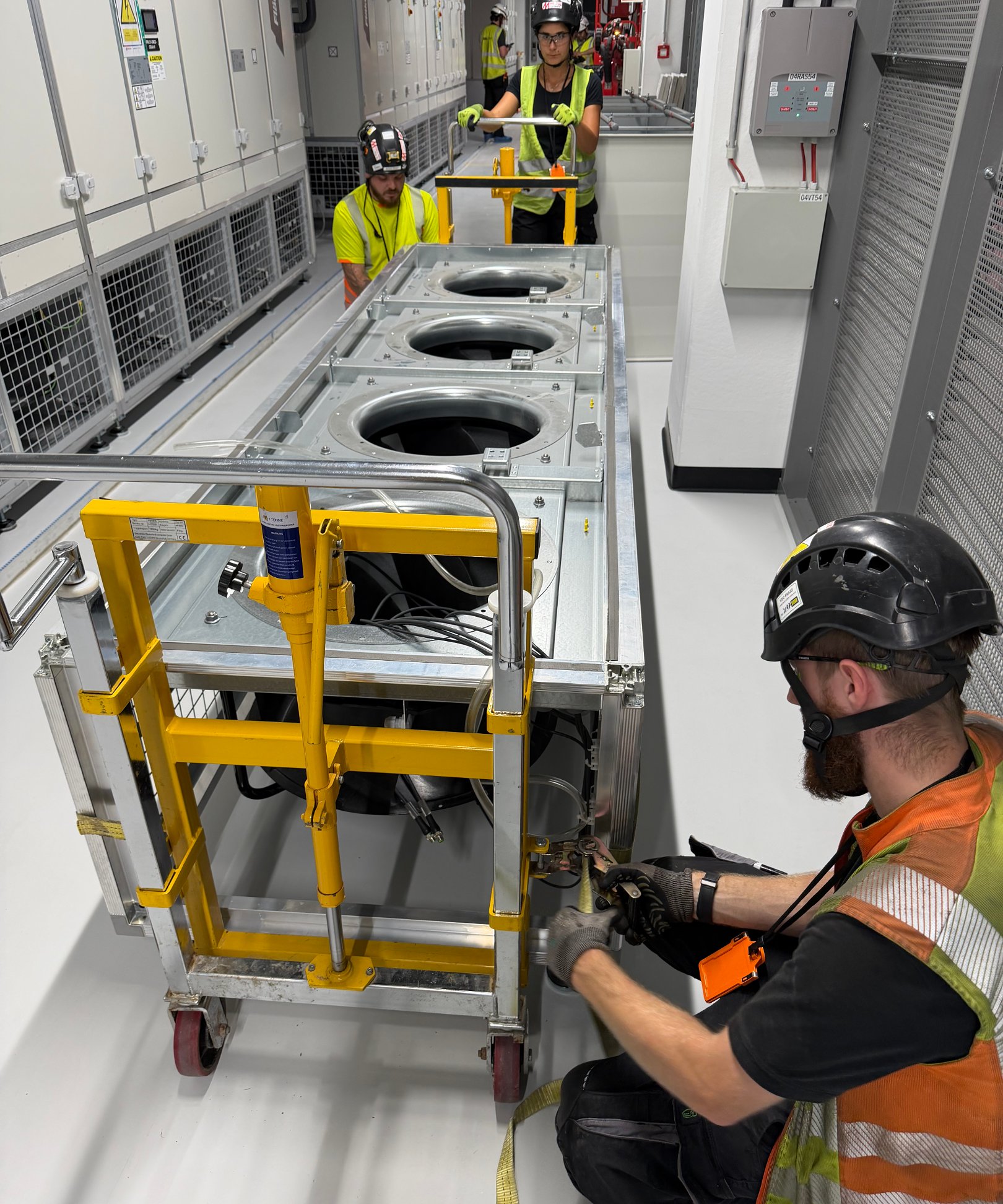 CRAH unit being moved on skates during replacement in a data center