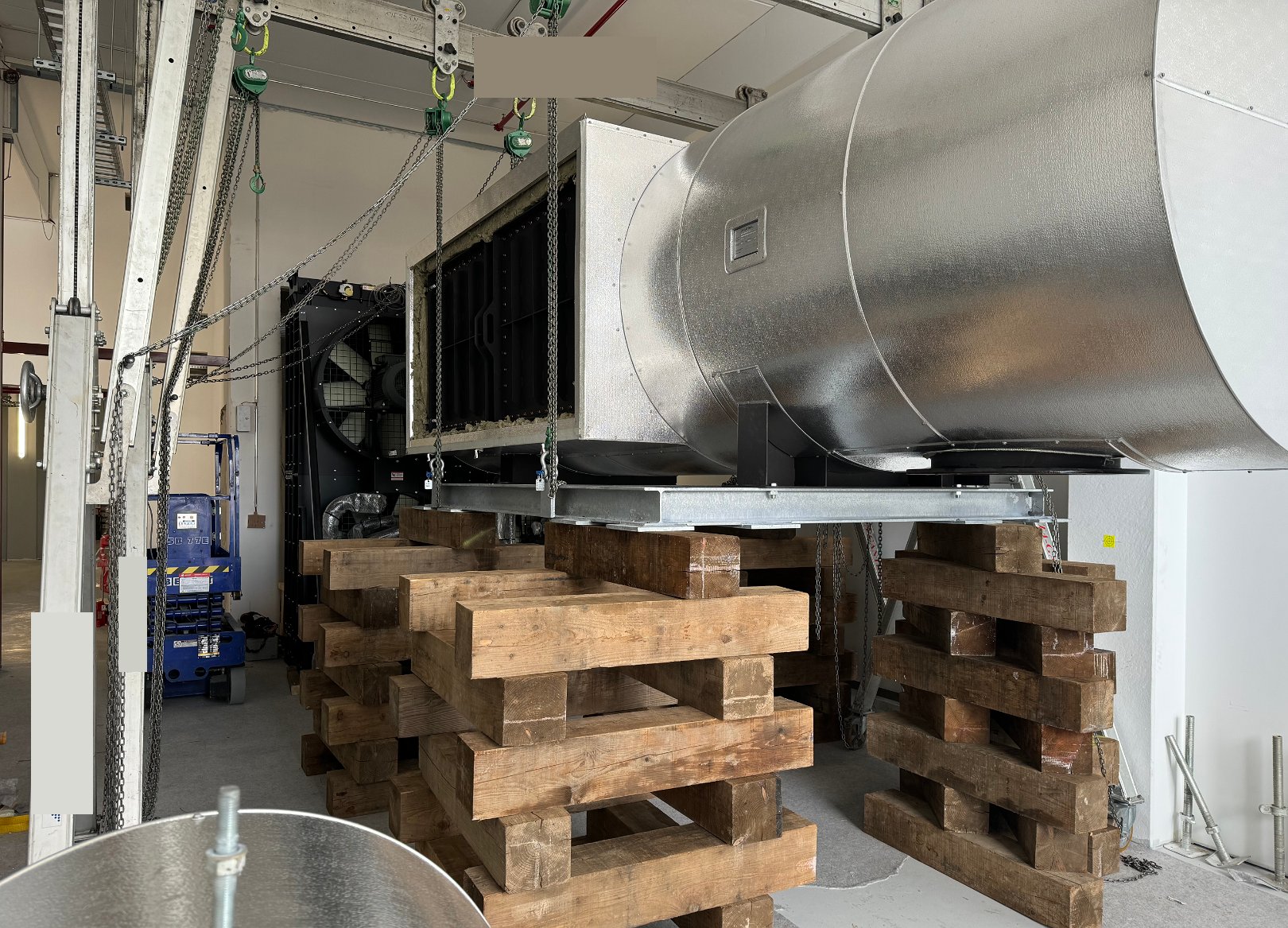 Fitters installing SCR system pipework on a data center generator in Frankfurt