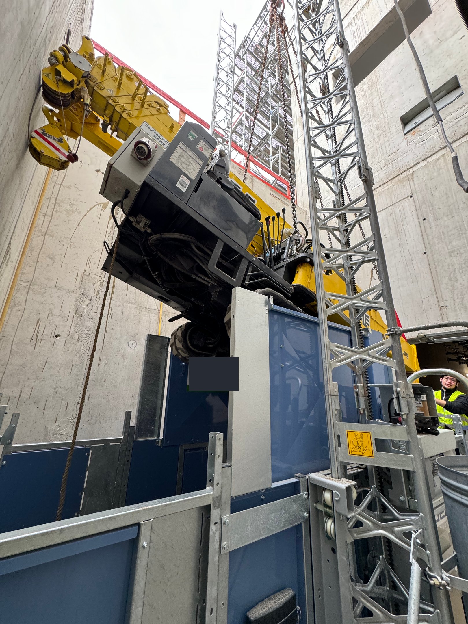 Spider crane retrieving a machine from the basement of a data center